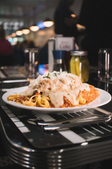 Diverse, appetizing dishes laid out on a busy lunch table at Diner 24